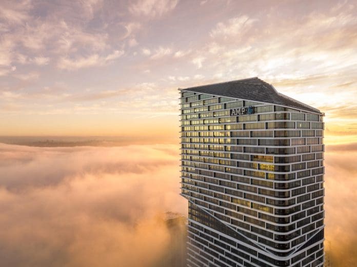 An aerial shot of Quay Quarter in Sydney emerging above the clouds