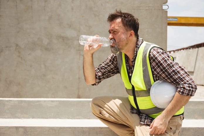 Male worker working in a very hot day. Heat wave project delays are the number one cause of delays, according to the state of trade survey
