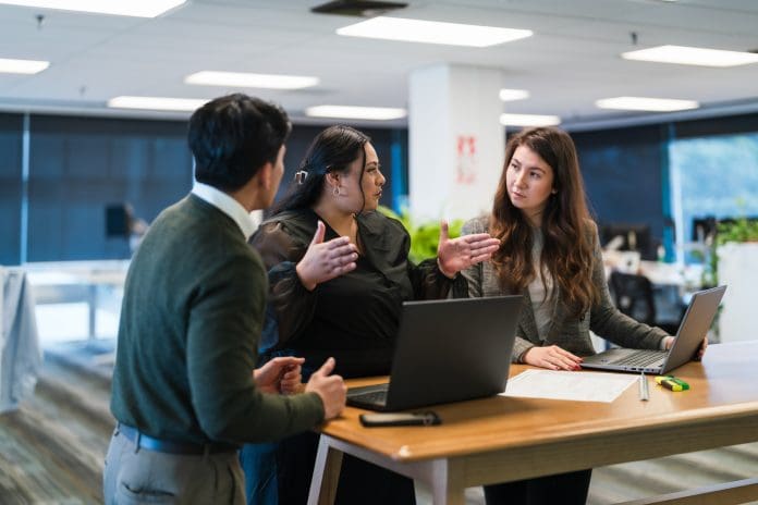 Partnership and collaboration in office, group discussion for feedback. The Asta suite was recommended as Kapitol's best option in project management software