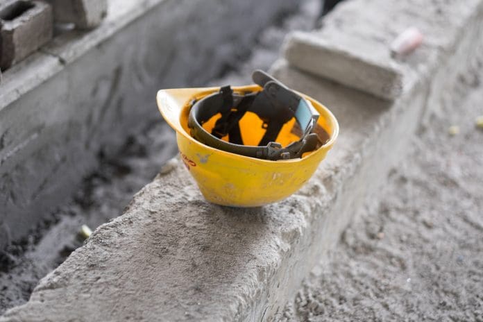 Hard Hat sitting on Rough Concrete The Ardmore Construction Group administrations is putting over 100 jobs at risk