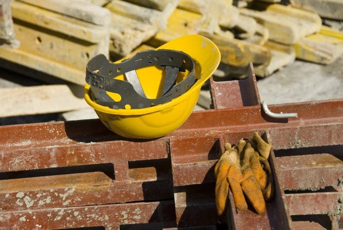 View of hard hat and gloves at construction site The state of the site leading to the construction worker's death was extremely dangerous