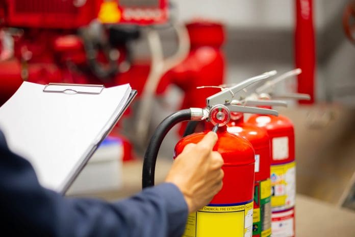 Engineer checking Industrial fire control system,Fire Alarm controller, Fire notifier, Anti fire.System ready In the event of a fire. The fire safety consultation reviews several parts of Approved Document B