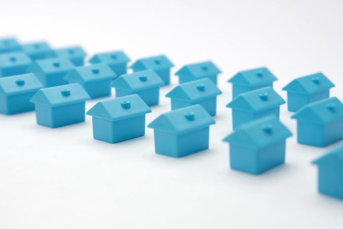 Real estate in cottage village. Home owner association. Rows toy houses. Miniature blue houses arranged in three rows. Miniature toy buildings. Many small houses. Miniature homes with property market Rows of toy blue houses. Miniature houses arranged in three rows. Model cottage settlement. Miniature homes. Many small houses. Real estate in cottage village. Model city neighborhood property market