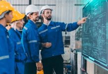 Securing the future: Tackling skills and talent challenges in the UK pump industry Engineer team training employee plan meeting. Plant staff worker safety technician group planning process discussion with digital white board present workflow.