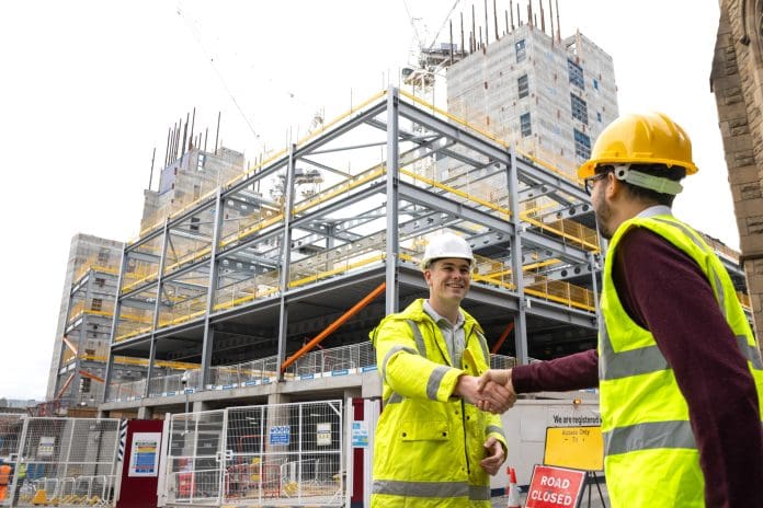 Handshake on Construction Site Construction sector confidence rises to 56% in July