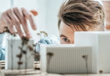 The power of “built in” building control expertise for architects partial view of young architect looking at self made building model in office