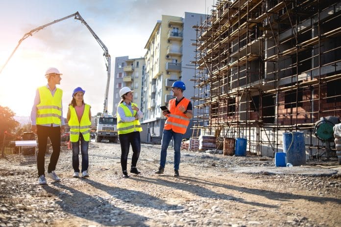 Construction workers having work meeting Research reveals strongest UK cities for starting a construction career
