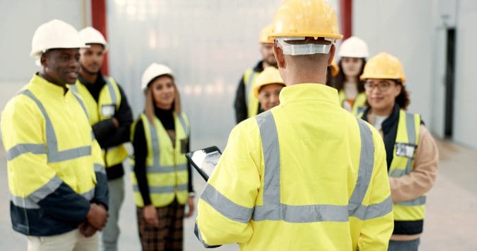 Construction, teamwork and people in meeting for planning, brainstorming and discussion in building. Architecture, engineering and men and women for inspection, training development and project Technical skills are to be offered to children as young as 14 soon