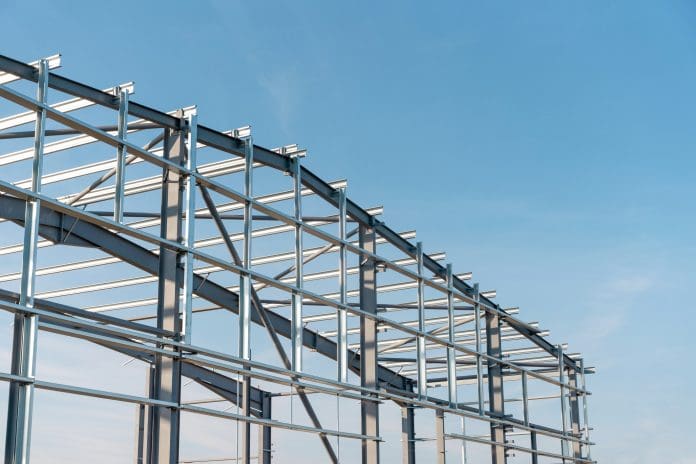 Construction process of new industrial building warehouse structure made of steel frame The RICS Construction Monitor shows an improved but still negative construction workload balance