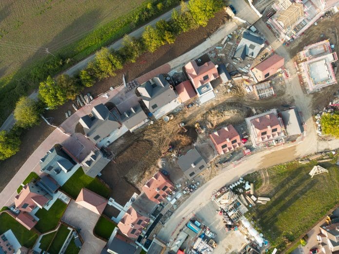 Drone top down view of two rows of new homes on a British housing estate.