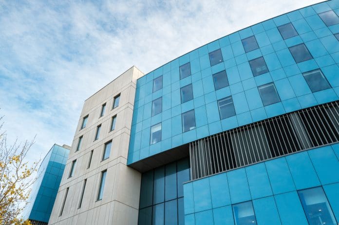 Abstract view of the newly built Royal Papworth hospital showing its modern and curved design. The latest glenigan construction review has good news for the construction industry pipeline