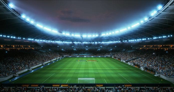 Professional Stadium With Football Game Championship Opening Ceremony. Soccer Teams Stand in Formation at Midfield Beneath Bright Floodlights as Packed Stands Roar and Anticipation Rises Before Kickoff. Why sports venues present some of the most complex maintenance challenges
