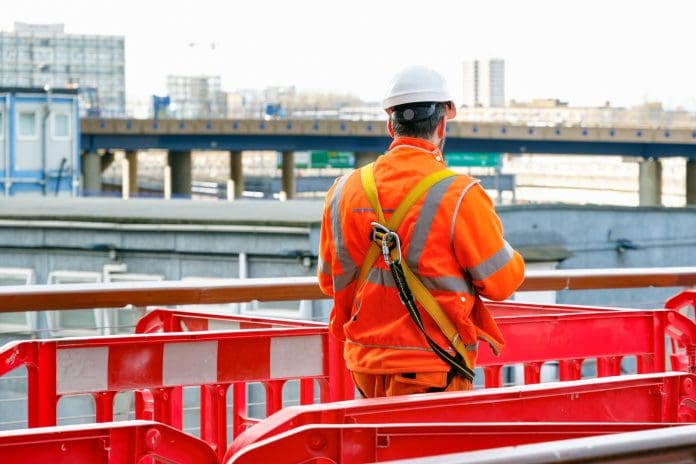 Back view of a construction worker walking into a building site in Canary Wharf, London Construction skills strategies must become more place-based, says CITB