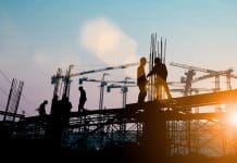 Construction skills training needs to go back to basics Silhouette of engineer and construction team working at site over blurred background sunset pastel for industry background with Light fair.Create from multiple reference images together.
