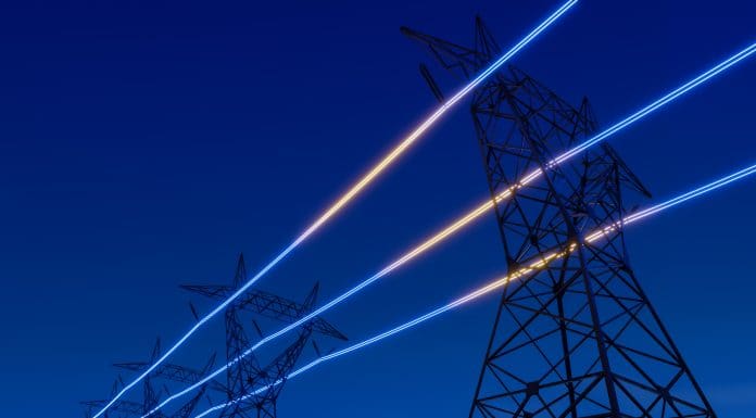 High voltage electric transmission tower with glowing current line, electrical power transmit through wire to city and house at night, Renewable green energy grid infrastructure concept 3d rendering