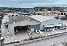 What MIS 3002 actually requires – and who it lets sign it off Aerial shot of a logistics warehouse