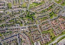 What needs to happen to finally tackle the housing crisis? Top down aerial photo of the British town of Middleton in Leeds West Yorkshire showing typical suburban housing estates with rows of houses, taken on a bright sunny day using a drone.