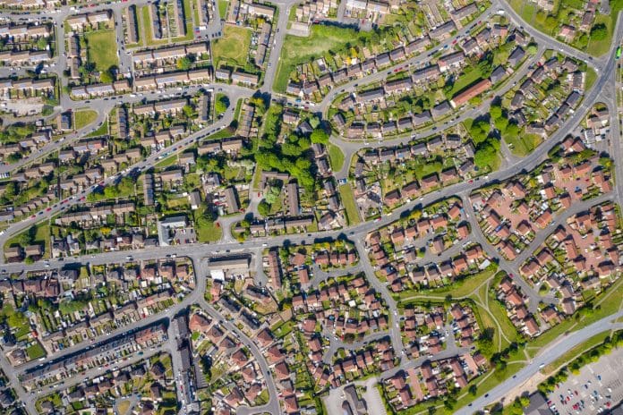 What needs to happen to finally tackle the housing crisis? Top down aerial photo of the British town of Middleton in Leeds West Yorkshire showing typical suburban housing estates with rows of houses, taken on a bright sunny day using a drone.
