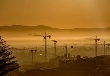 Building design with climate change in mind Construction Tower Cranes City Scape in the distance at sunrise Cape Town