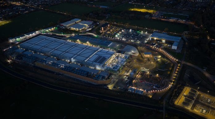 Data center under construction at Waltham Cross, England. computer systems and associated components, such as telecommunications and storage systems. Artificial intelligience and Cloud services. Expanasion of IT technology. Aerial drone video at night.
