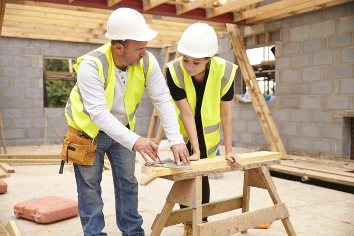 Carpenter With Female Apprentice Working On Building Site The construction skills academy will create new workers in the West Midlands