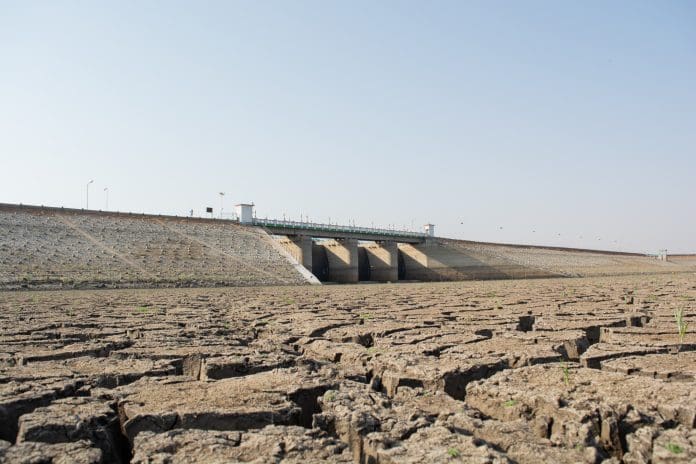A dried up empty reservoir or dam during a summer heatwave, low rainfall and drought in north karnataka,India Why thinking about drought and flooding as separate issues just isn’t working