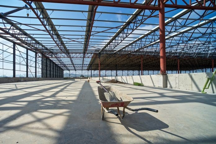 Warehouse Construction Site Wheelbarrow and shovel Mixed signals in UK construction as contract awards rise, but starts fall