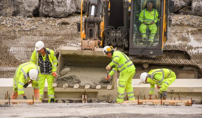 Construction workers using concrete to strengthen sea defences Changes to construction right to work are important to employers and contractors alike