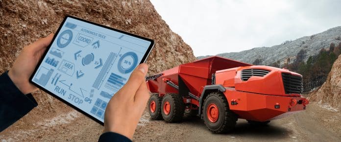 Man controls autonomous mining truck Automation in construction is shifting