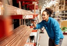 Compliance without compromise: Managing product traceability in building materials manufacturing A worker uses a barcode reader.