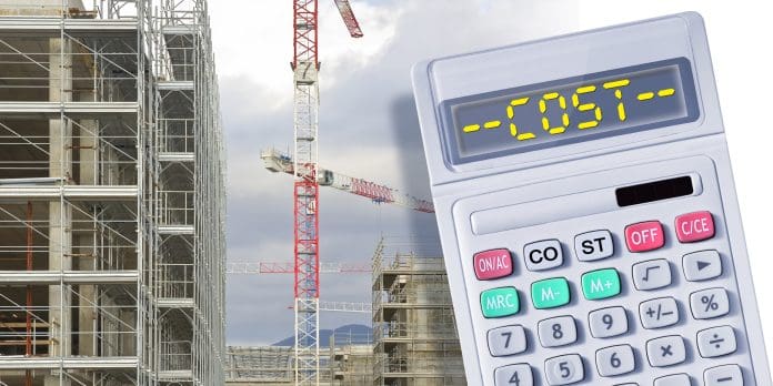 Costs about costruction industry - Construction business abstract concept and calculator - Building activity investment metaphor 9 in 10 Irish building supplier firms fear delayed payments this winter
