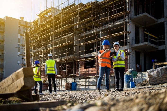 Four construction workers having meeting Get Britain Building: Better places, stronger communities, and a resilient economy