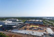 Data centres and planning reform: Which route to take Aerial view of a data center being constructed among existing centers.
