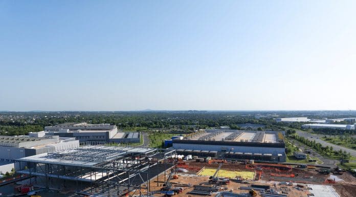 Aerial view of a data center being constructed among existing centers.