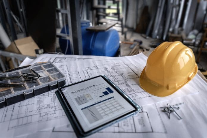 Construction project planning using tablet and blueprints on site Simply holding supplier evidence isn’t enough: How can construction prepare for rising compliance demands?