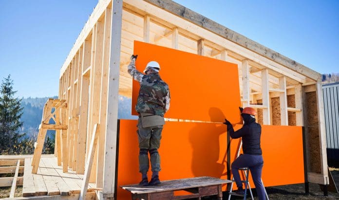 wood-based-panels-being-placed-onto-timber-frame-house-scaled wood-based panels being placed onto a timber frame house